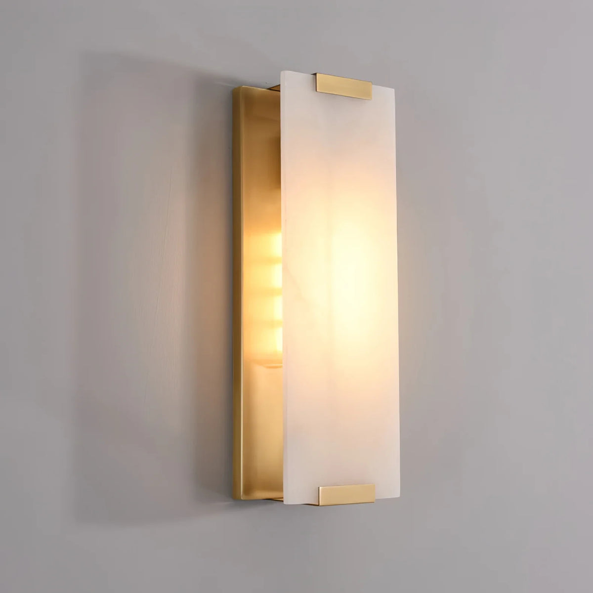 Illuminated Modern Brass Alabaster Flat Wall Sconce Studio Shot on Grey Background
