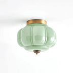 Modern Minimalist Green Pumpkin Art Glass Flush Mount Ceiling Light with Antique Brass Canopy on Pure White Background