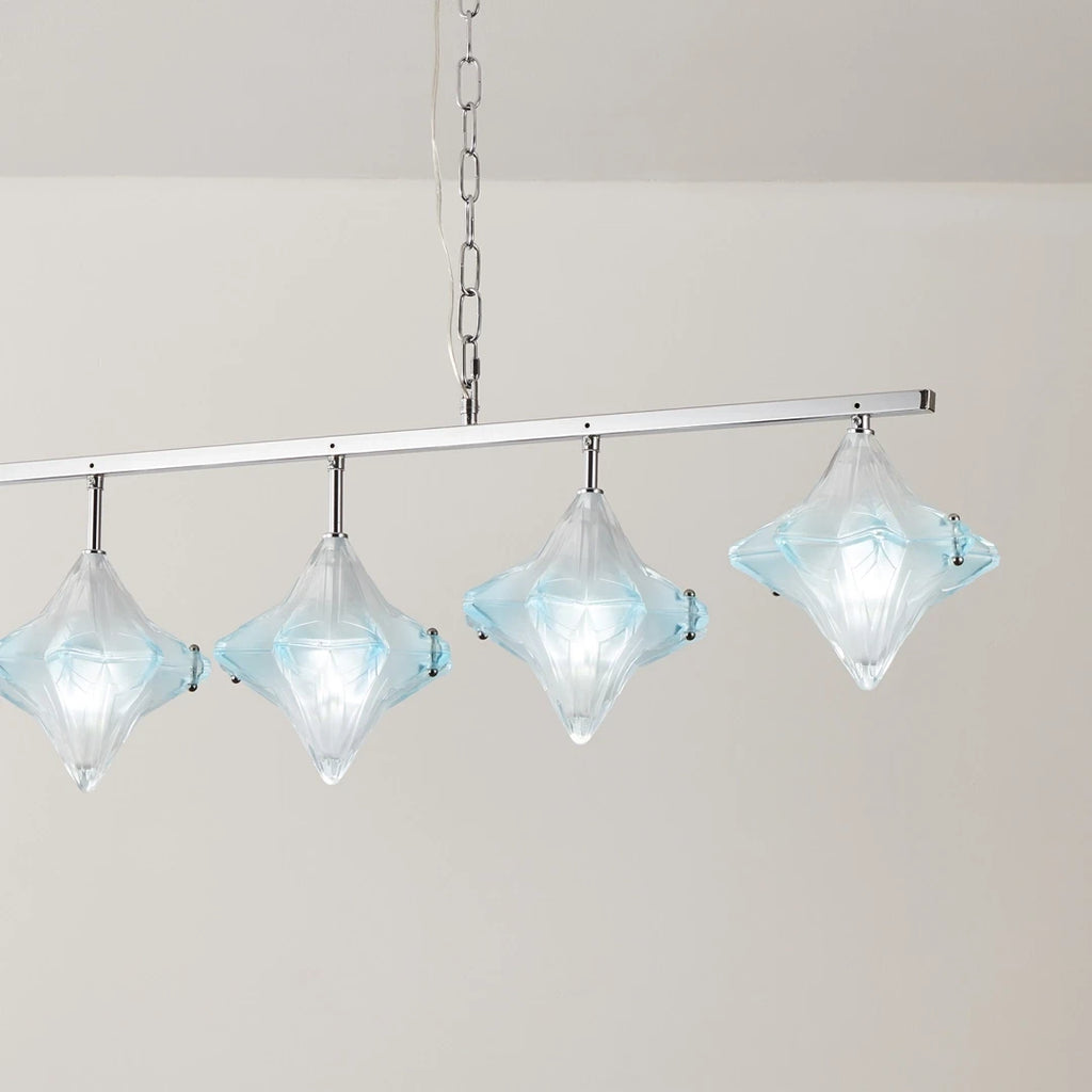 Angled View of Illuminated Modern Star Art Glass Linear Chandelier