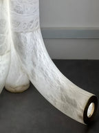 Close Up View of Curved Alabaster Base and Brass Ring Accent