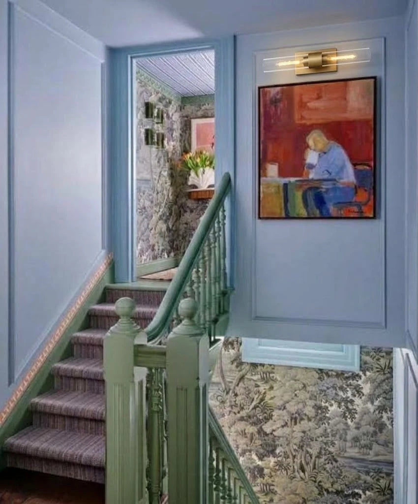 Modern Brass Cylinder Wall Sconce Along Stairway Corridor