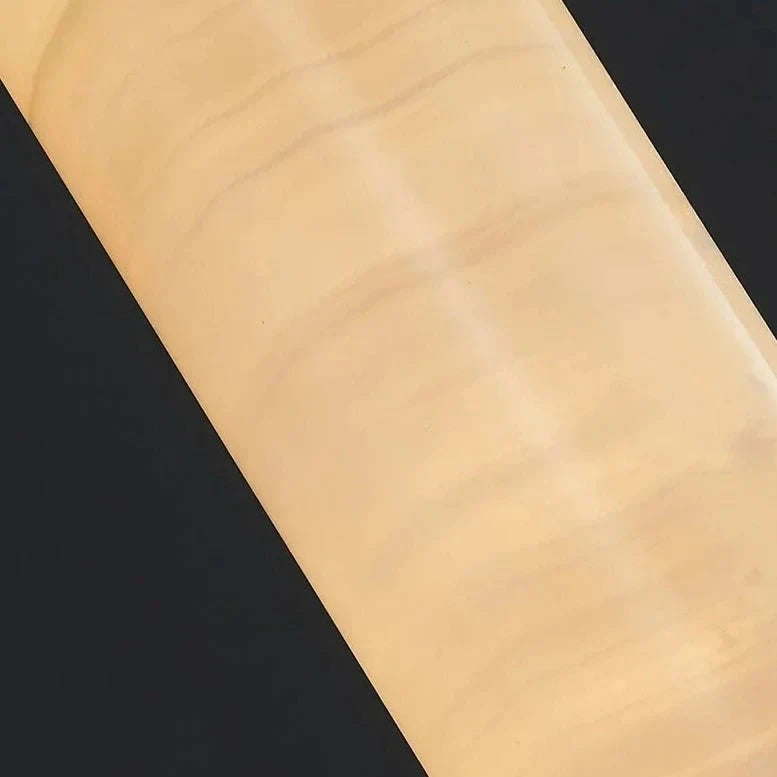 Close Up View of Illuminated Alabaster Cylinder Shade and Natural Stone Veins