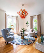Modern Orange-Red Iridescent Round Disc Art Glass Chandelier in Stylish Sitting Area