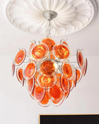 Upward View of Illuminated Modern Silver Frame Orange-Red Iridescent Chandelier Studio Shot