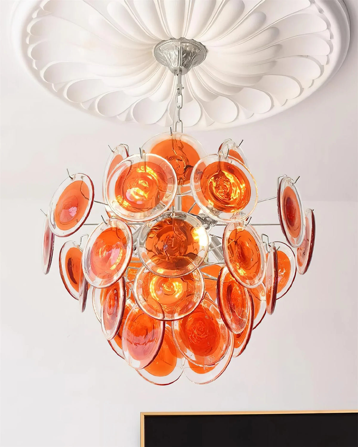 Upward View of Illuminated Modern Silver Frame Orange-Red Iridescent Chandelier Studio Shot