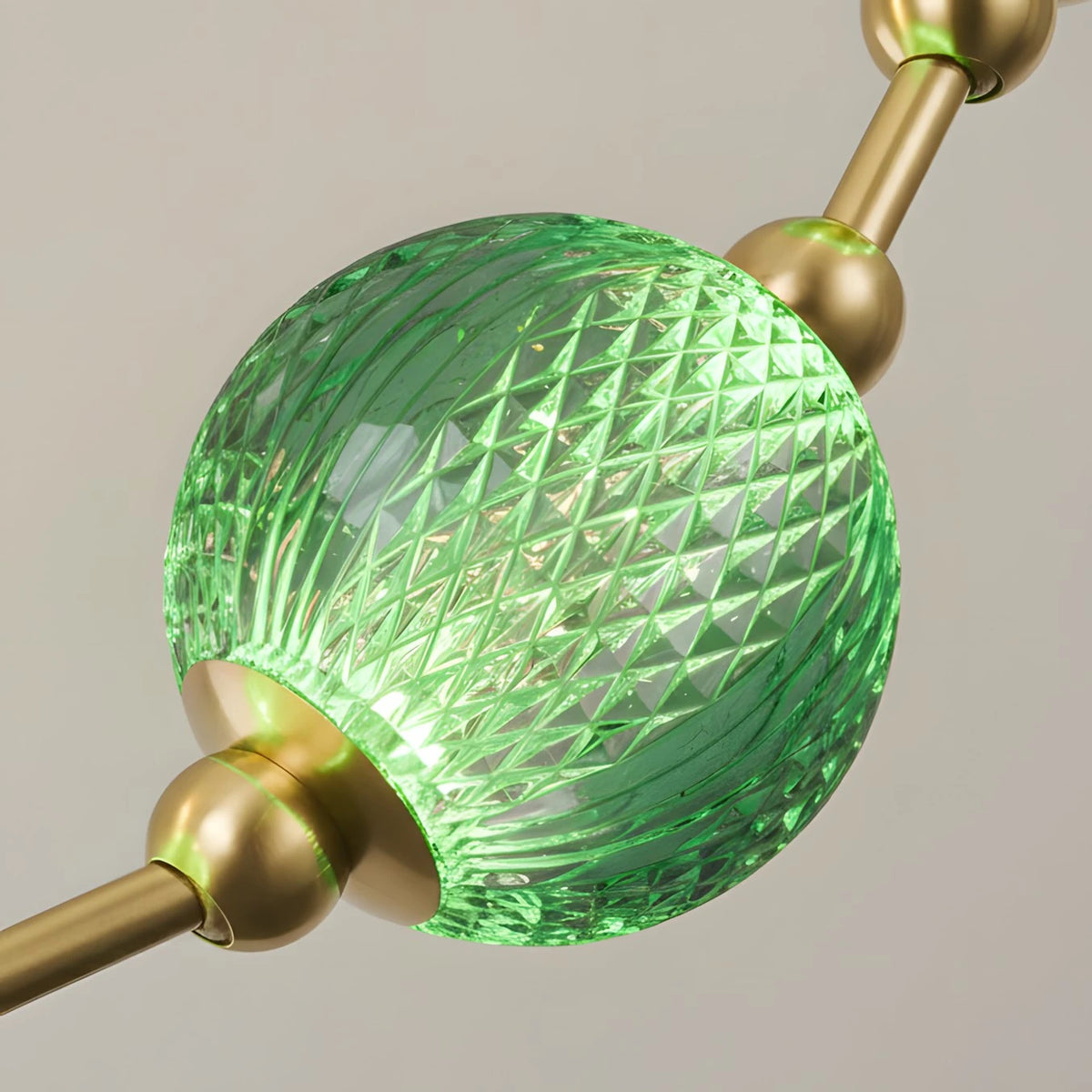 Close Up of Emerald Green Diamond Textured Glass Globe and Brass Fitting