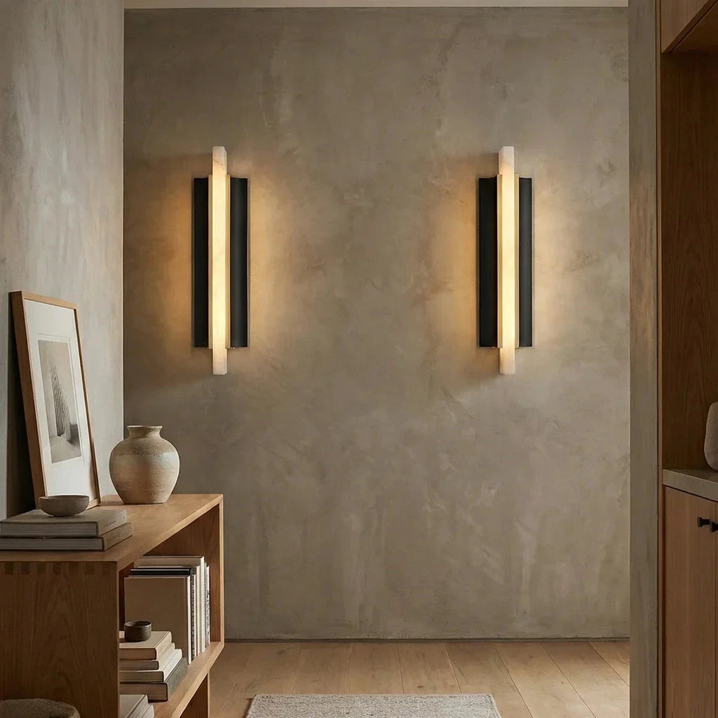 Pair of Illuminated Alabaster Pillar Sconces on Textured Wall