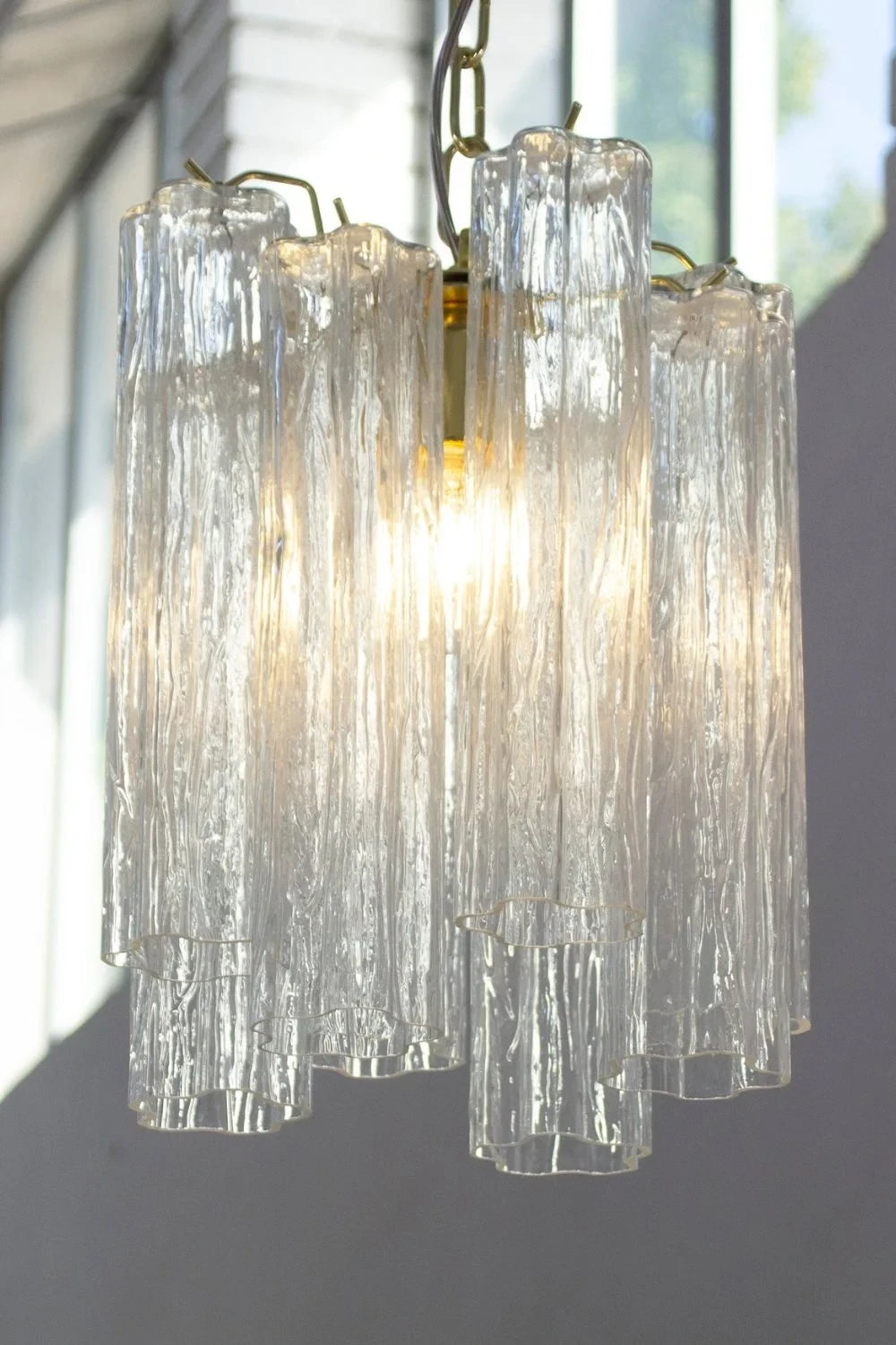 Illuminated Modern Silver Frame Fluted Art Glass Pendant Light Studio Shot