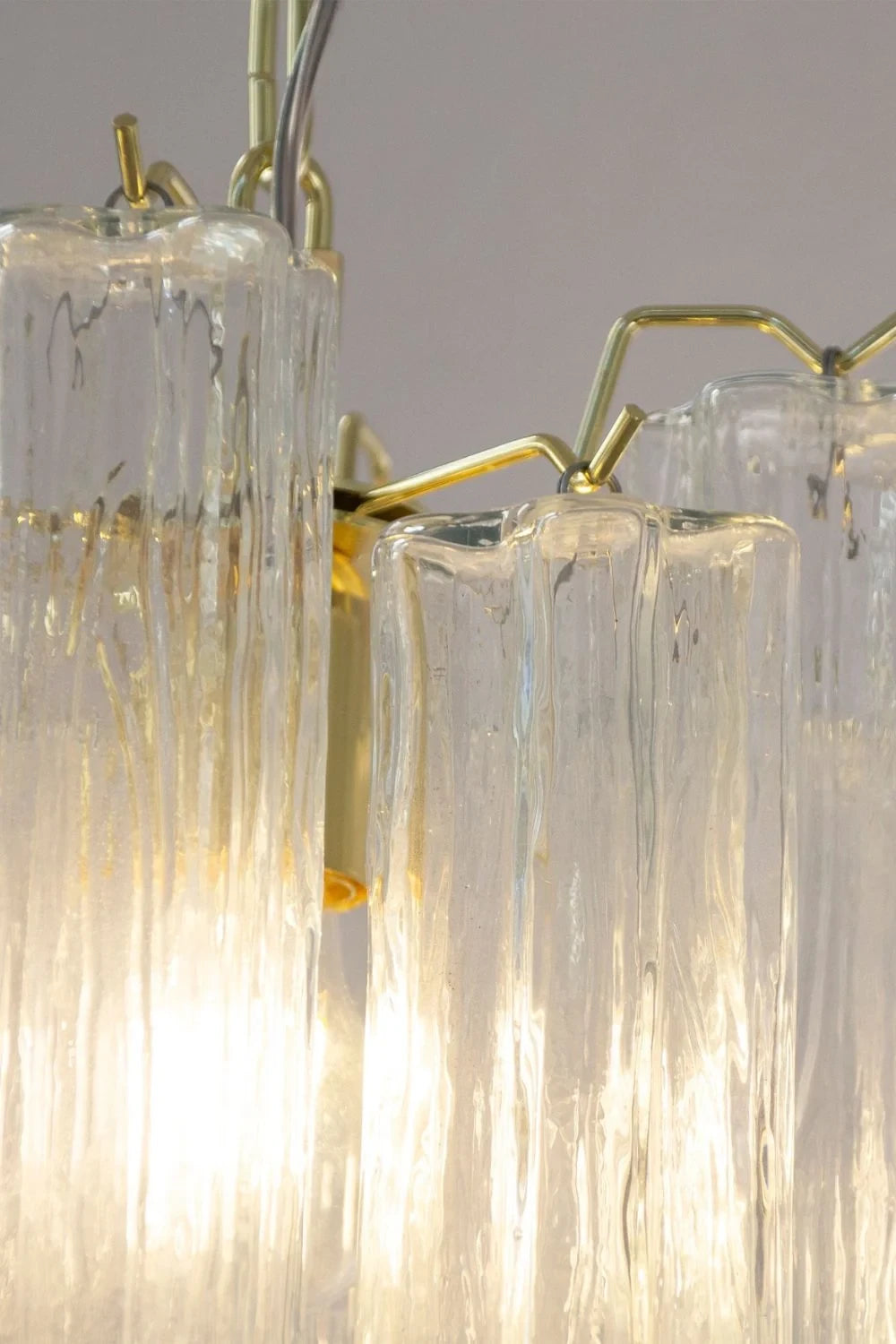 Close Up View of Illuminated Fluted Art Glass Tubes and Brass Connectors