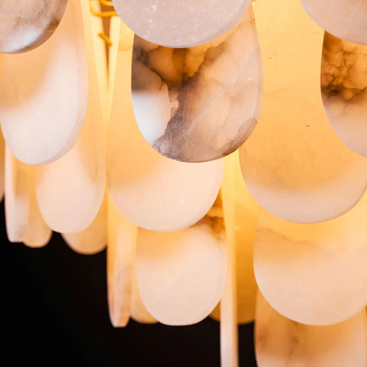 Close Up of Glowing Alabaster Stone Shades and Brass Frame