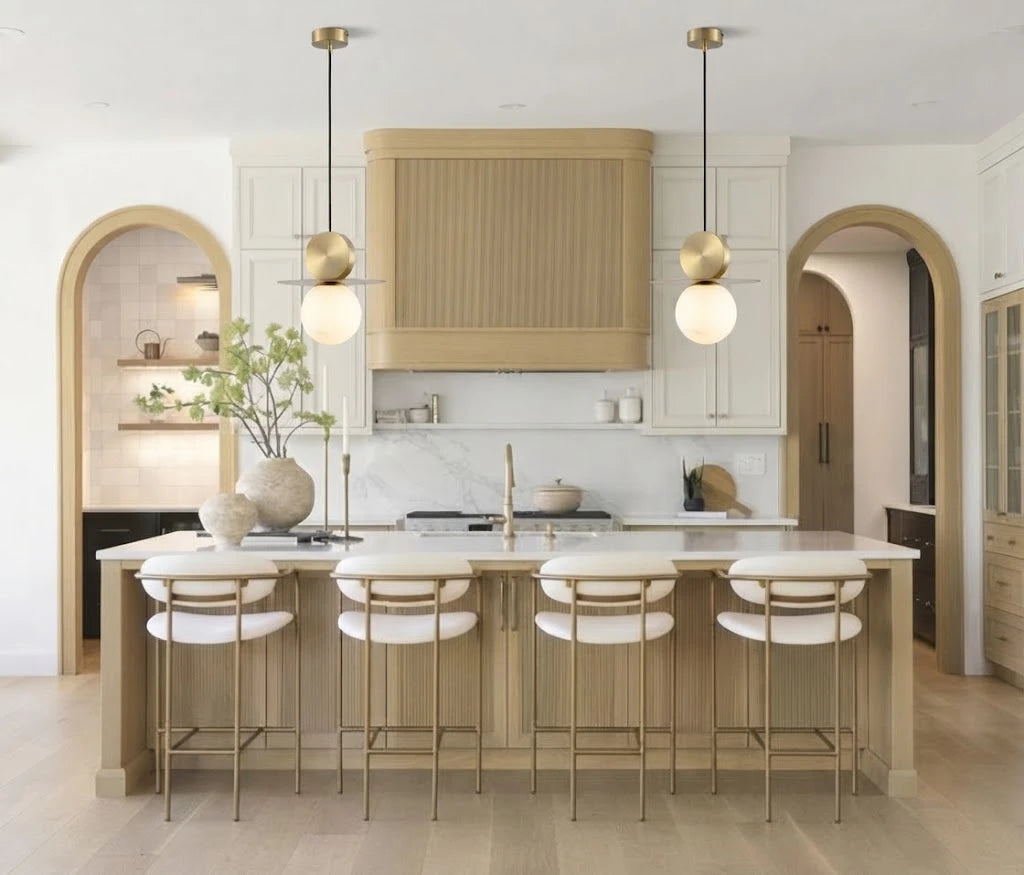 Modern Brass Disc and Globe Pendant Lights Over Kitchen Island