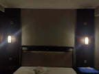 Pair of Alabaster Cylinder Sconces Installed Beside Bed