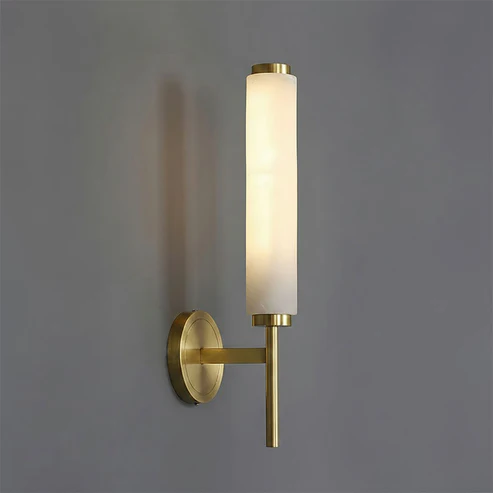 Single Brindisi brass alabaster wall light vertical cylinder shade minimalist grey wall shot