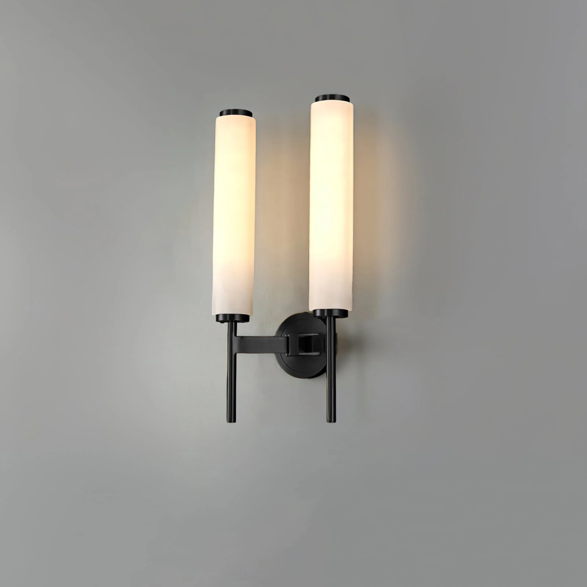 Dual head Brindisi alabaster wall lamp matte black frame illuminated on neutral grey wall