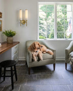 Modern Brass Cylinder Wall Sconce in Living Room Corner
