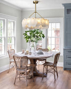 Modern Natural Shell Ring Chandelier Over Round Dining Table