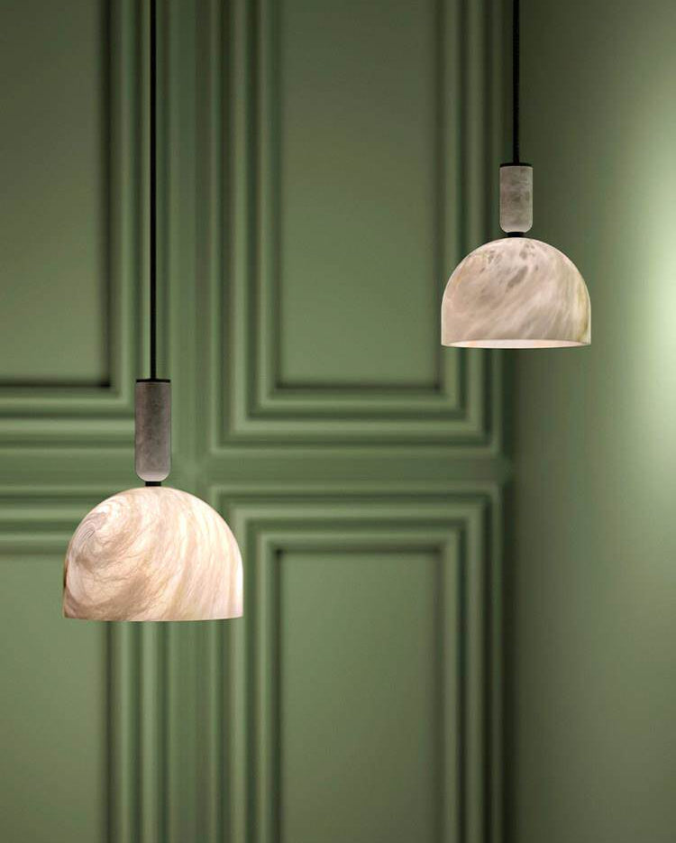 Two Cairo Dome alabaster pendant lights mounted beside dark green panel wall