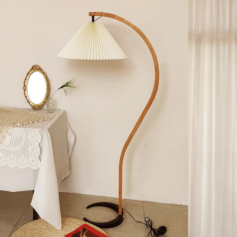 Caprani Floor Lamp curved wooden stand with white pleated lampshade, vintage home decor scene beside console table and decorative mirror