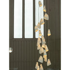 Cascading Porcelain Cone Chandelier Near Arch Window