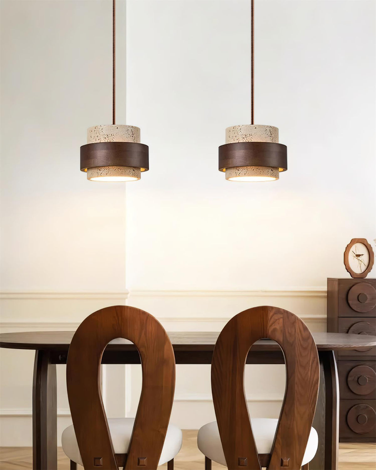 Two travertine wood pendant lights hanging above wooden dining table japandi dining space