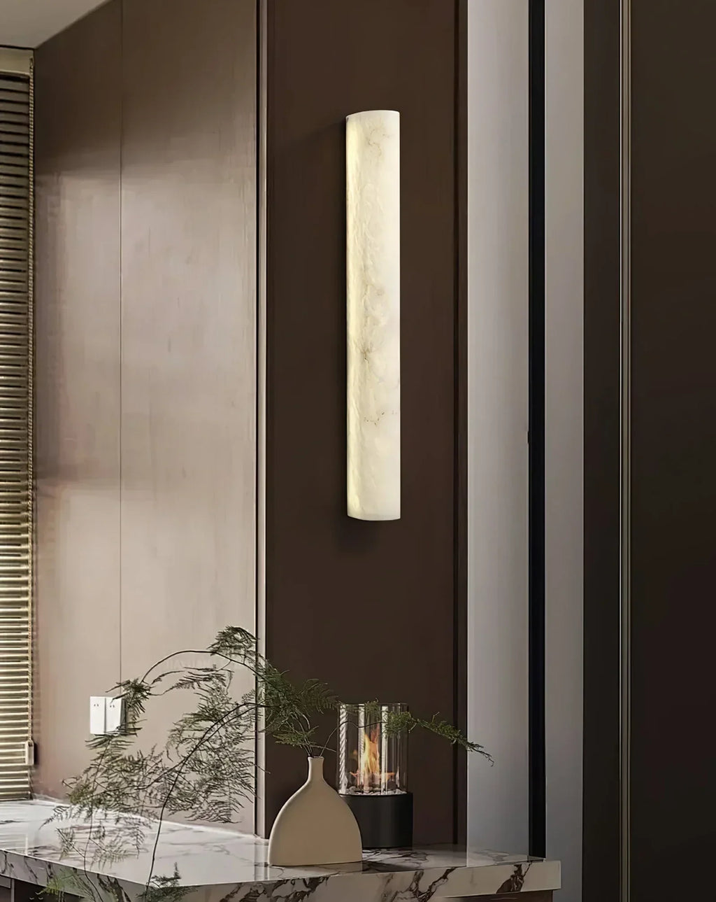 Modern Vertical Cylindrical Alabaster Wall Sconce on Dark Wood Wall
