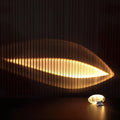 Leaf Shaped Light Reflection Cast on Slatted Wall