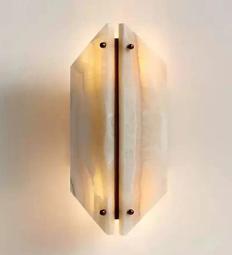Geometric Travertine Sconce Glowing Warm Light on White Background