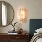 Modern Stone Wall Sconce next to Bedroom Credenza and Round Mirror