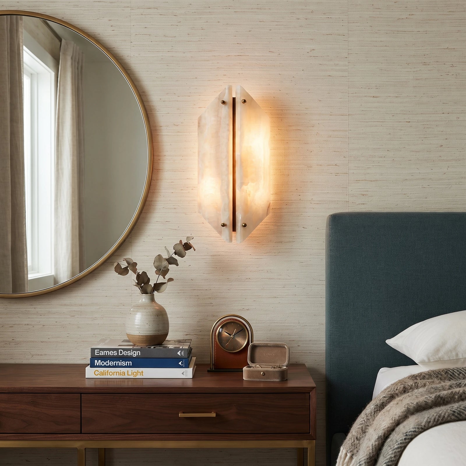 Modern Stone Wall Sconce next to Bedroom Credenza and Round Mirror