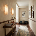 Pair of Travertine Wall Lights Illuminating Elegant Hallway