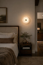 Modern Natural Marble Round Disc Wall Sconce in Warm Bedroom Interior