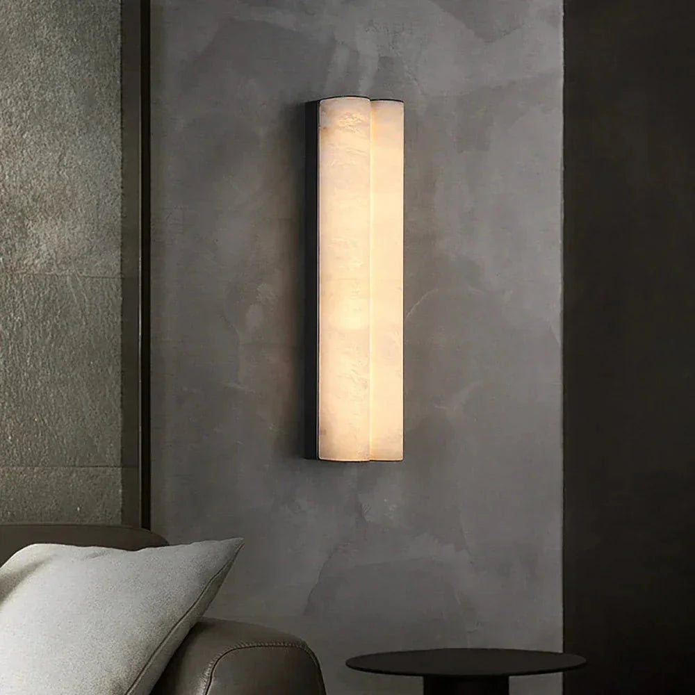 Double Cylinder Alabaster Wall Sconce Over Bedside Table