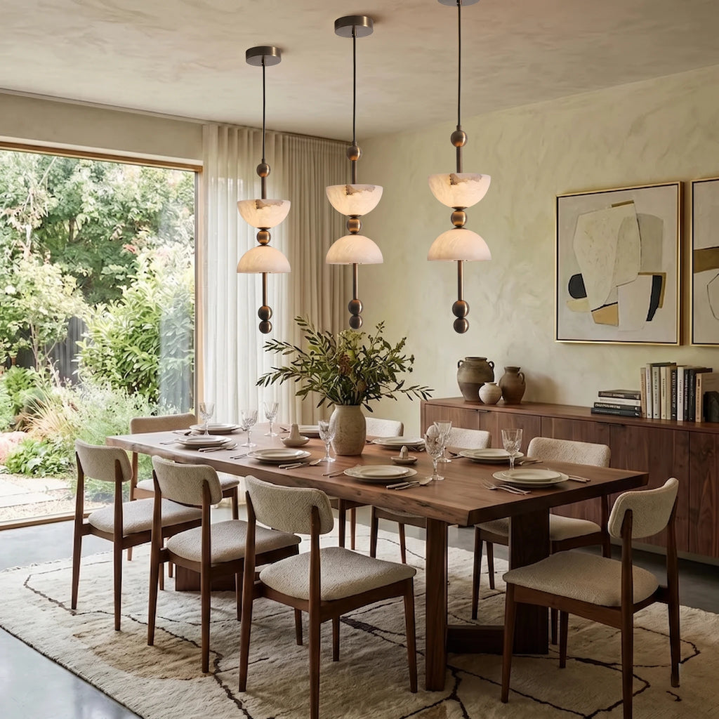Trio of Modern Alabaster Pendant Lights Over Dining Table