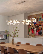 Modern Extended Gold Ginkgo Leaf Chandelier Over Long Dining Table
