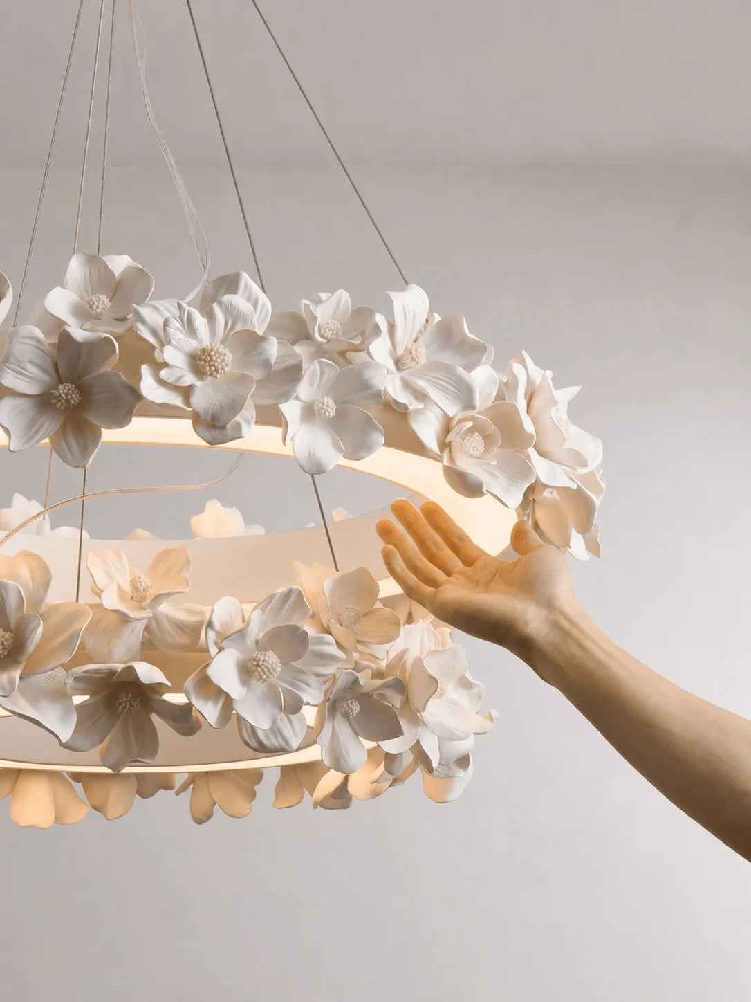 Hand Adjusting Petals on Modern Floral Ring Chandelier