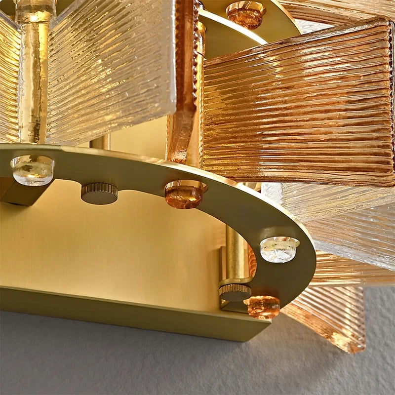 Close Up View of Modern Brass Wall Canopy and Amber Striped Glass Connection Details