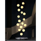 Long Cascade Globe Alabaster Chandelier Over Modern Stairwell