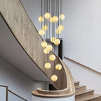 Cascading Alabaster Sphere Chandelier Over Spiral Stairwell
