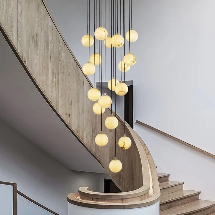 Cascading Alabaster Sphere Chandelier Over Spiral Stairwell