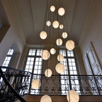Bottom Up View of Cascading Alabaster Globe Chandelier Over Foyer