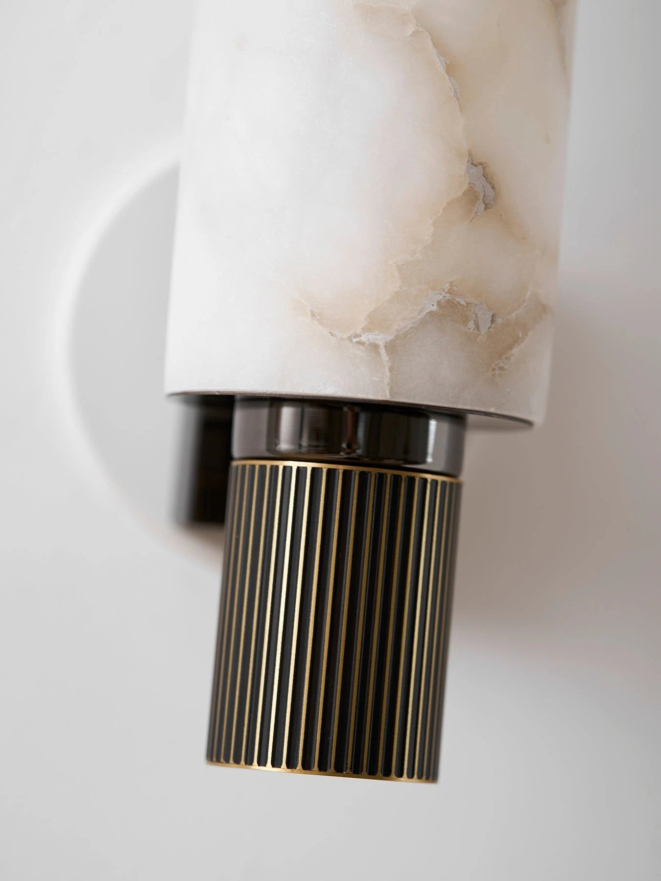 Detail View of Fluted Brass Column and Alabaster Base