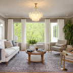 Gold Feather Glass Chandelier in a living room with a dark fireplace feature wall