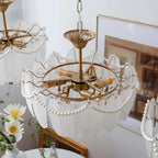 Detailed view of the chandelier's translucent ivory glass shades with feather-like textures