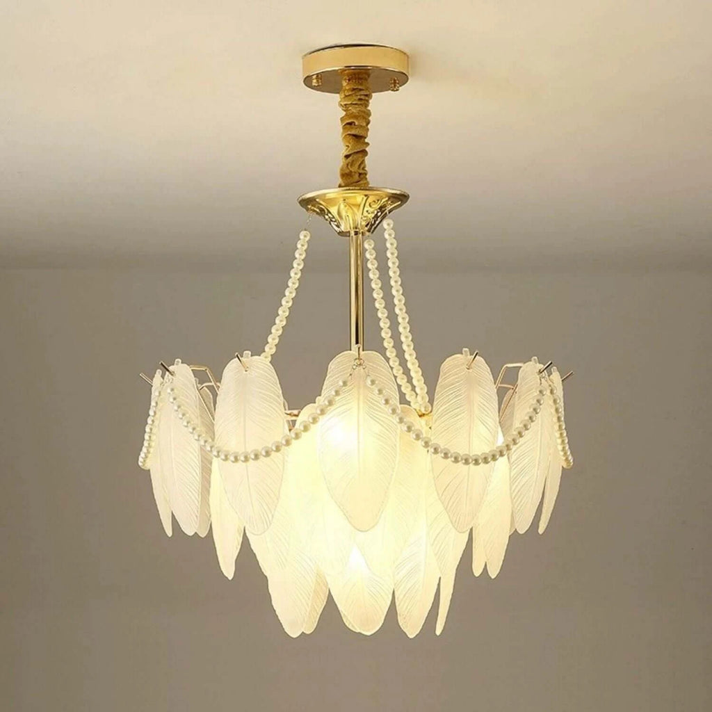 Close-up of the Gold Feather Glass Chandelier's gold frame and glass shade connections