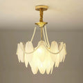 Close-up of the Gold Feather Glass Chandelier's gold frame and glass shade connections