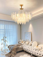 Gold Feather Glass Chandelier in an elegant neutral living room with large windows