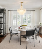Gold Feather Glass Chandelier above a dining table in a bright dining room