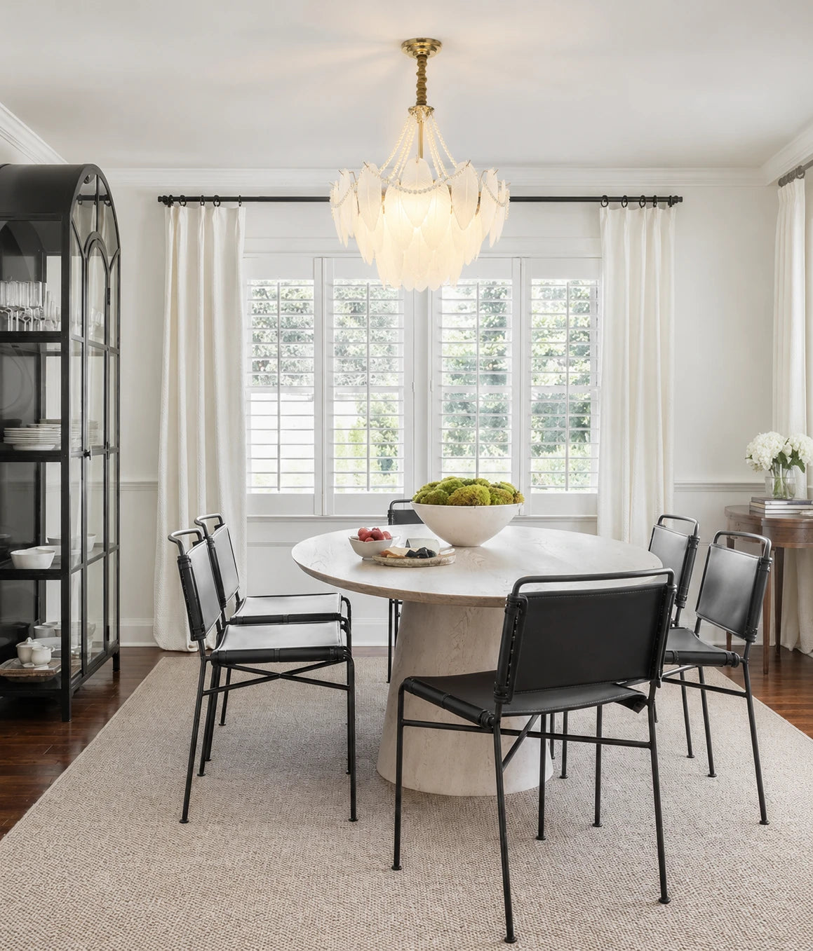 Gold Feather Glass Chandelier above a dining table in a bright dining room