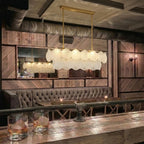 Modern Brass Scale Art Glass Linear Chandelier in Retro Lounge Bar Setting