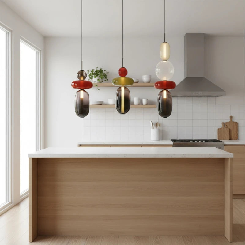 Trio of Glass Totem Pendant Lights Over Kitchen Island